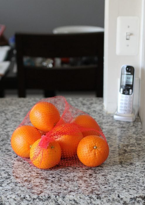 Mesh bag of oranges.