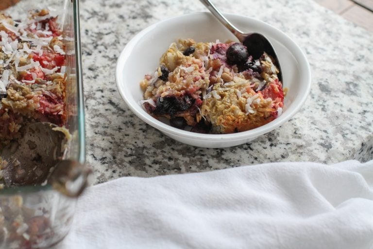 A bowl of baked oatmeal, sitting on a countertop.