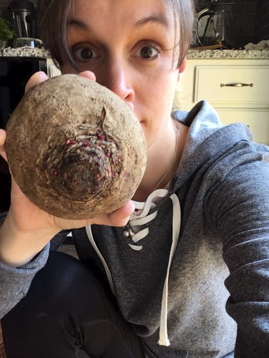 Kristen holding a huge beet.