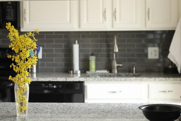 Kitchen with white cabinets and granite countertops.