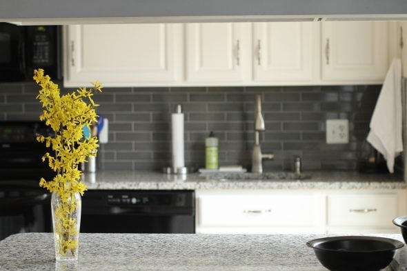 A kitchen with white cabinets.