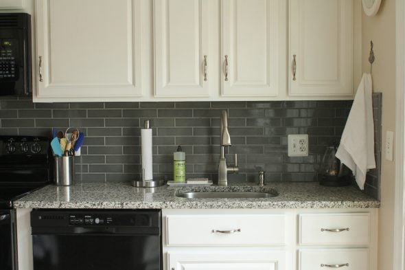 gray ceramic tile backsplash with white cabinets.