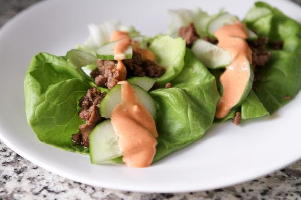 Korean lettuce wraps on a white plate.