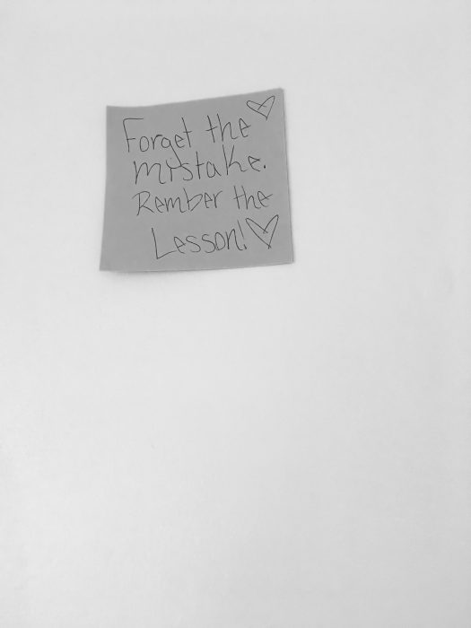 Post it that says "forget the mistake, remember the lesson".