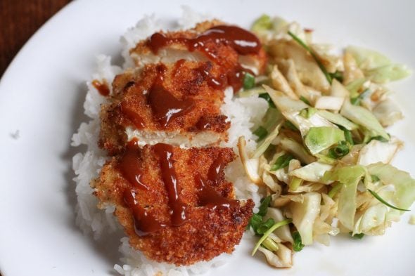 Chicken katsu on rice, on a white plate.