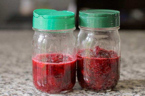 Parmesan lids on two glass Mason jars.