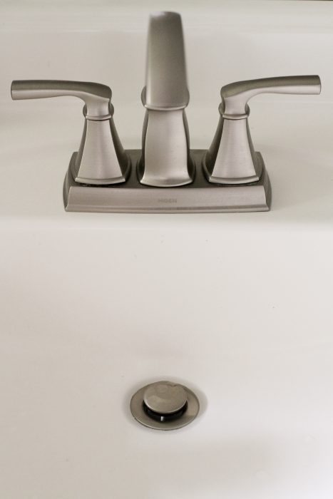 A Moen Hensley silver bathroom faucet.