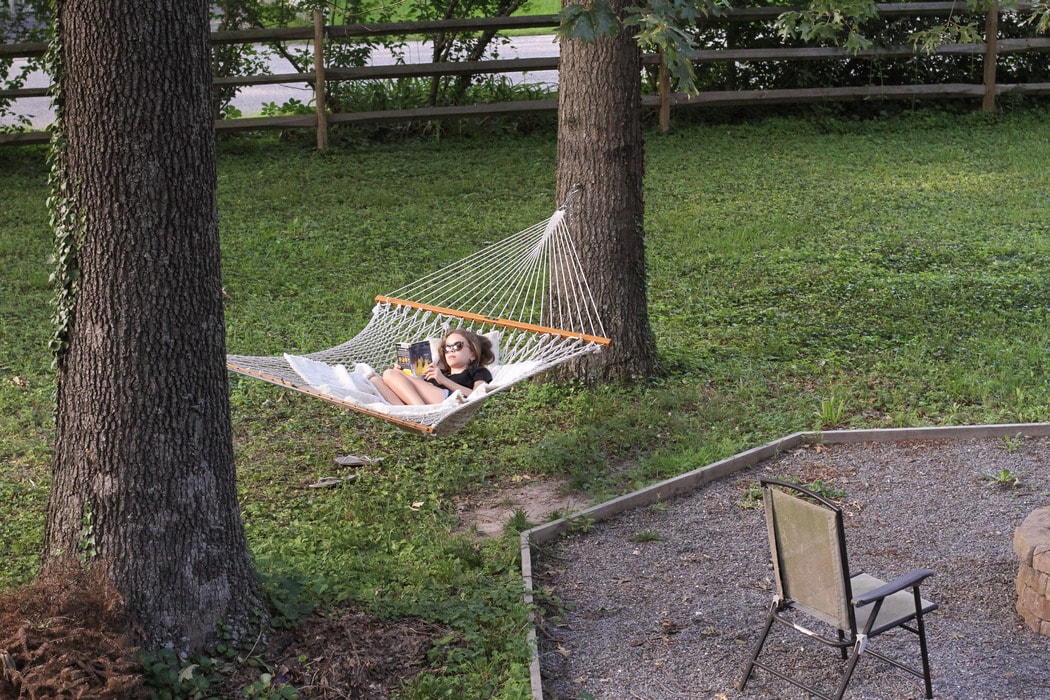 A girl lounging on a hammock.