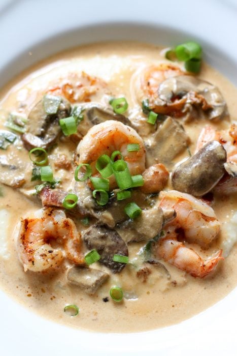 shrimp and grits in a white bowl.
