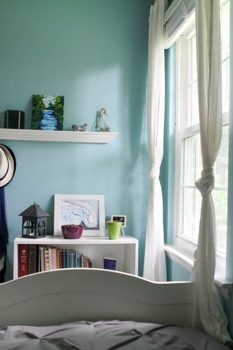 white bed with aqua walls