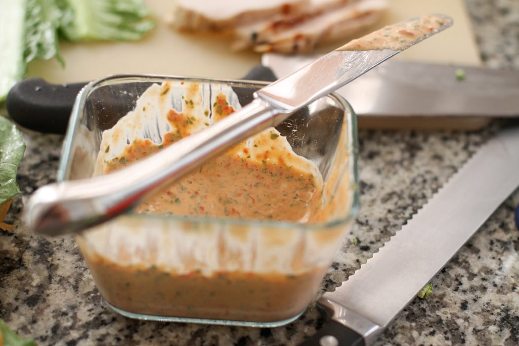 Red pepper and basil mayo in a glass dish.