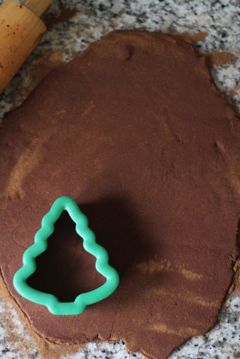 Christmas tree cookie cutter in cinnamon applesauce dough