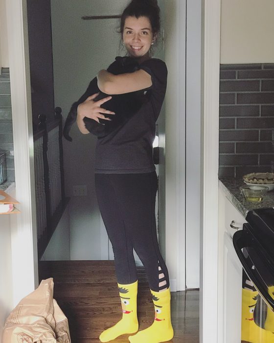 Lisey holding a cat and wearing Bert socks