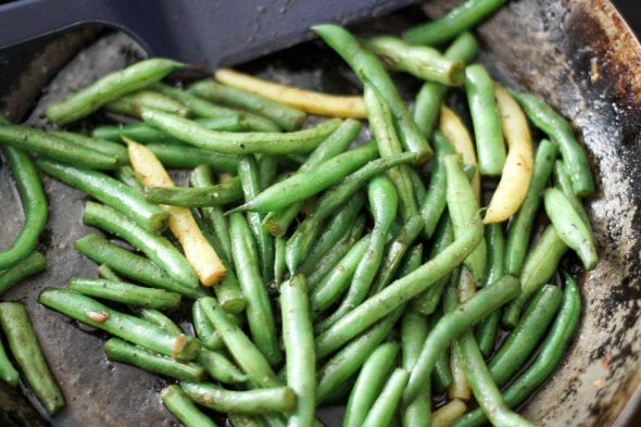 Sautéed green beans in a skillet.