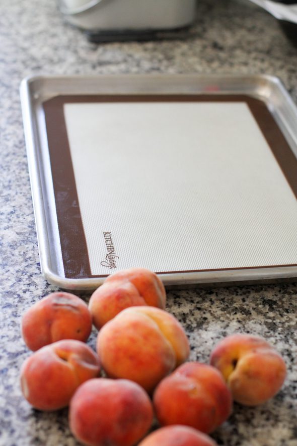 Baking sheet lined with silpat for peach freezing