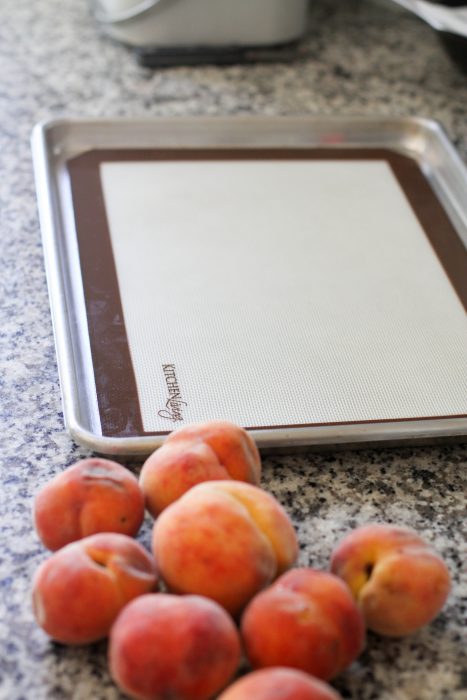 Baking sheet lined with silpat for peach freezing