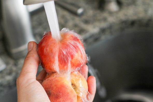 peaches being washed in the sink