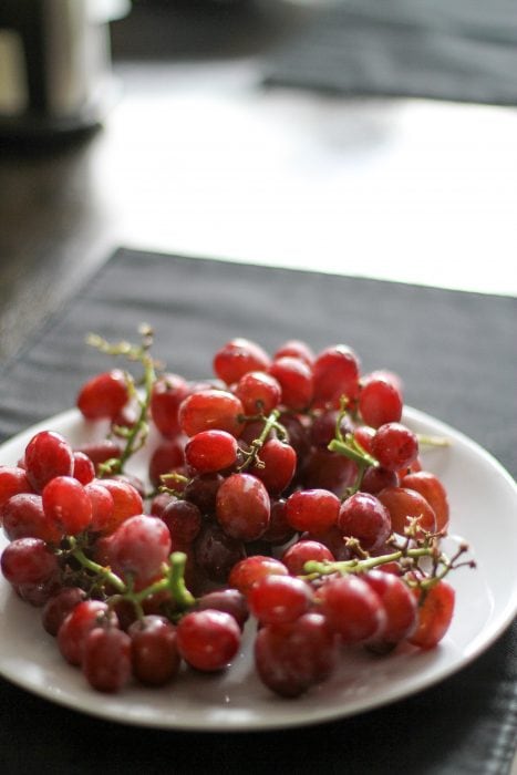 red grapes on a white plate