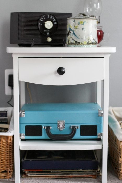 teal record player on white shelf