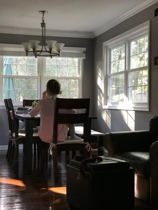 Sonia sitting in the dining room