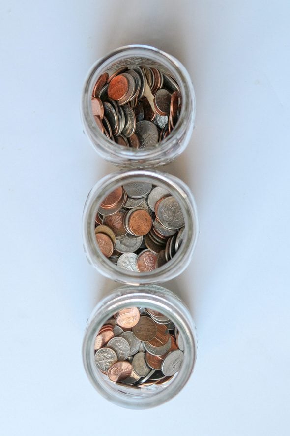 Three glass jars filled with coins.
