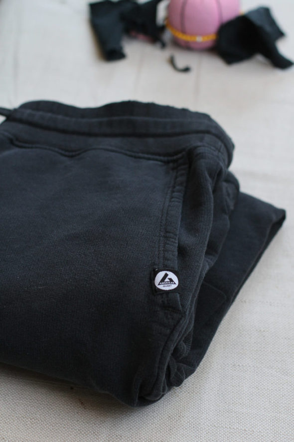 A black pair of American Giant joggers, folded up.