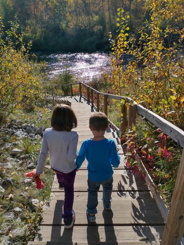 Kids walking toward a river.