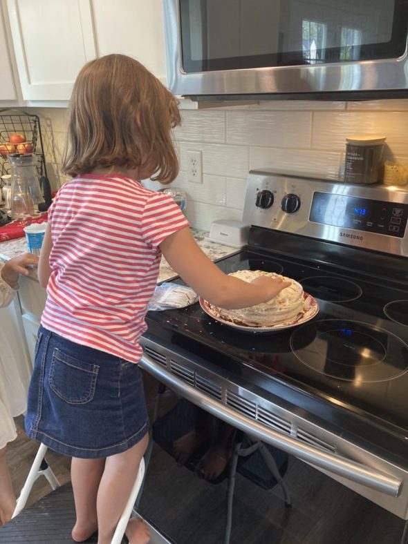 little girl making a dessert