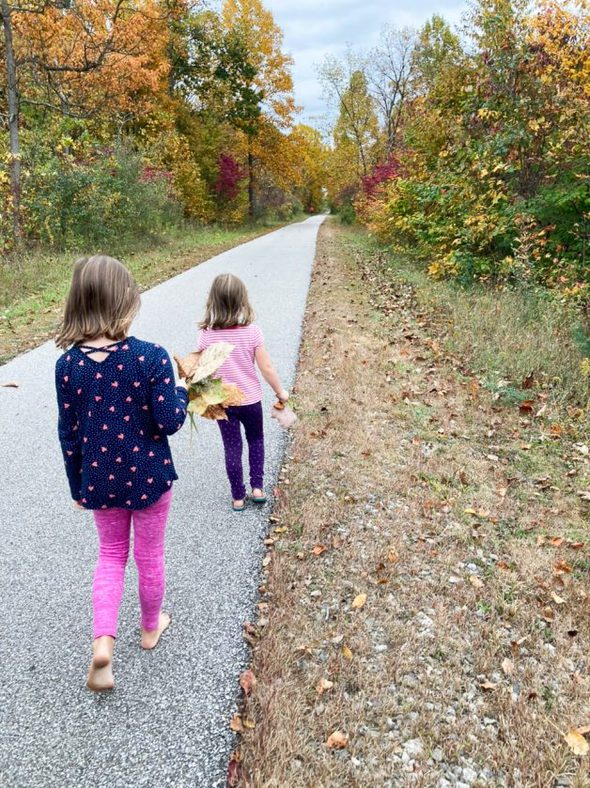 two girls walking on a path