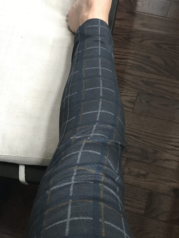 Kristen's leg in a pair of plaid pants.