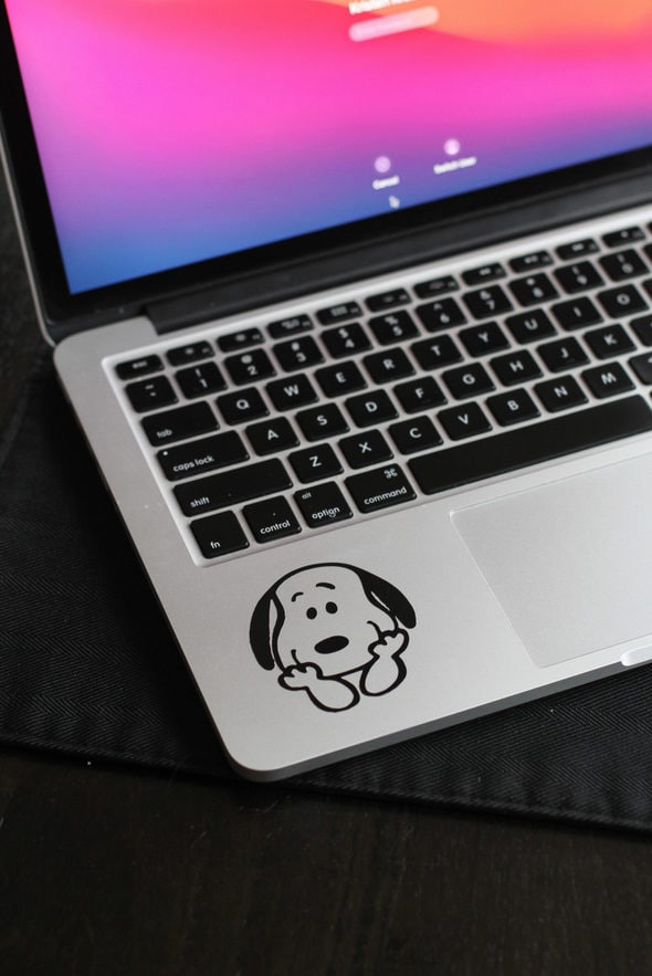 Kristen's laptop with a small Snoopy sticker.