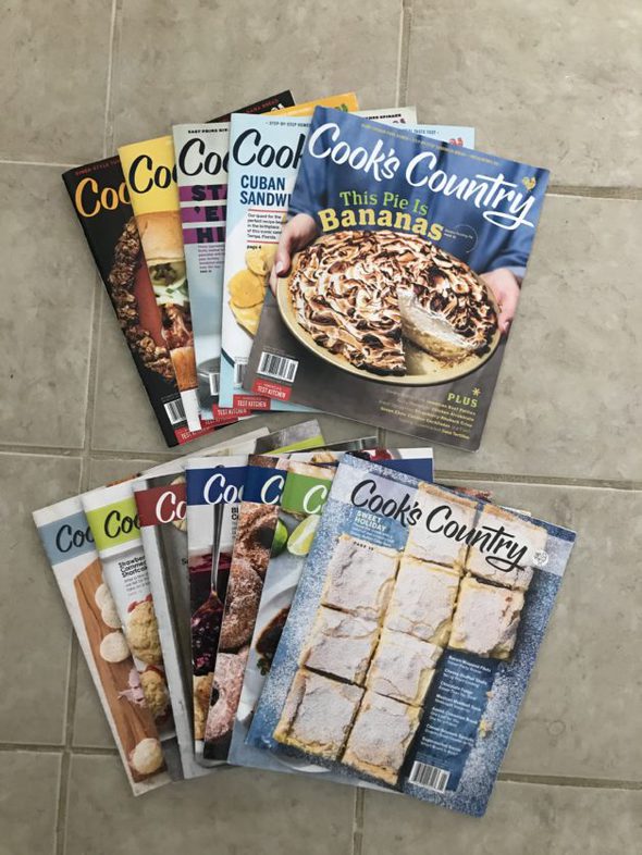 Cook's Country magazine back issues spread out on the floor.