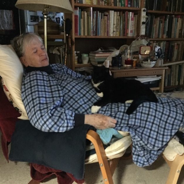 Erika with tuxedo cat on lap.