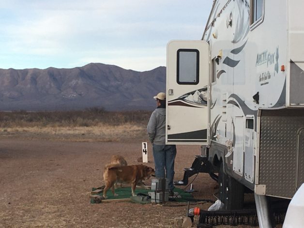 Cindy standing next to her fifth wheel camper.