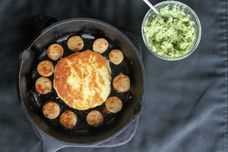Potato patty with sausage and guacamole.