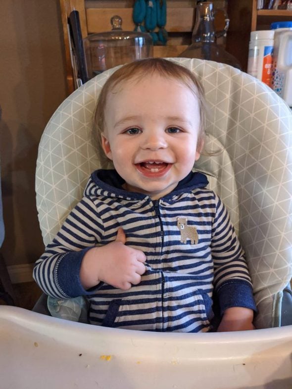 Reese's son in a high chair.