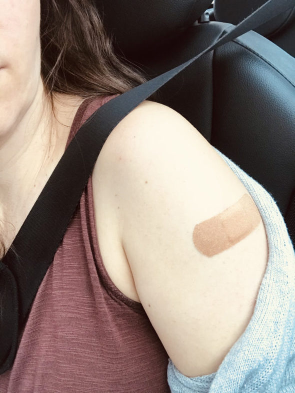 Band-aid on Kristen's arm from a vaccine.