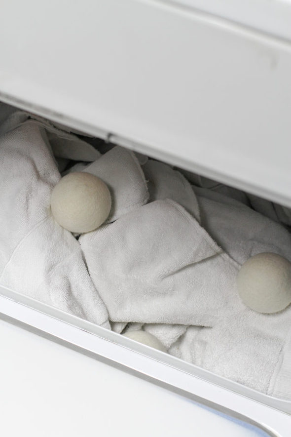 Dryer balls in a dryer with white towels.
