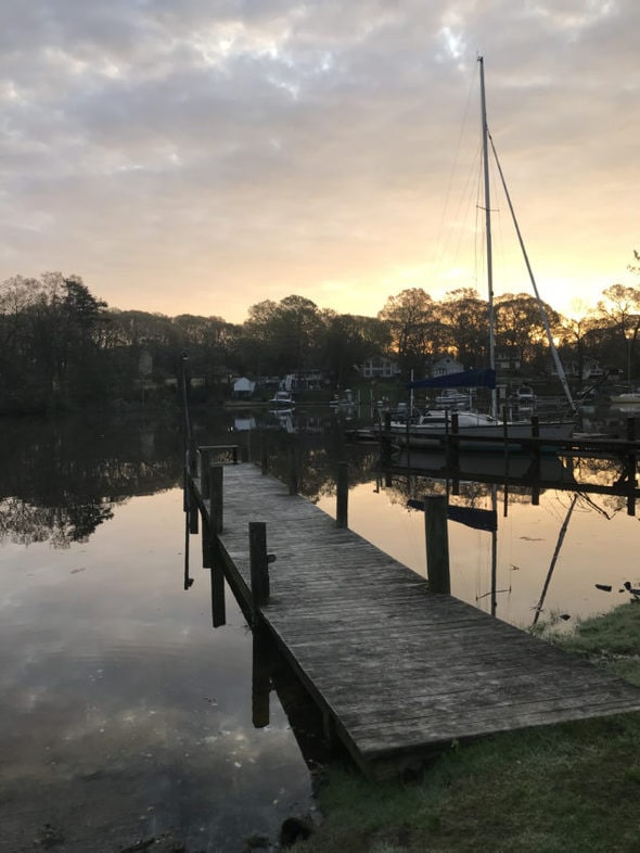 A dock on the river at sunrise.