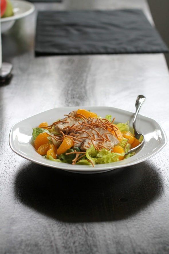 Mandarin chicken salad in a white bowl.