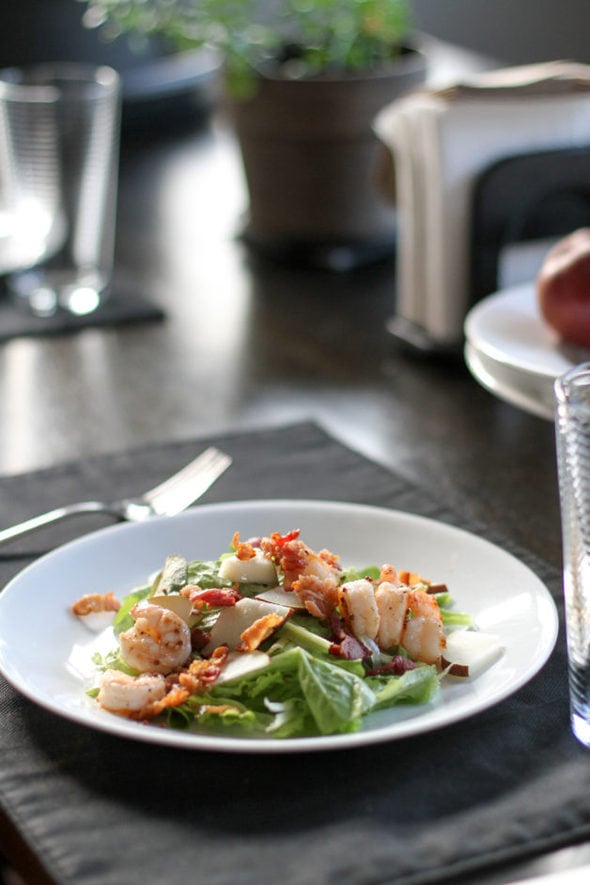 Green salad topped with shrimp.