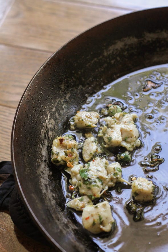 Small chicken pieces cooked in a skillet.