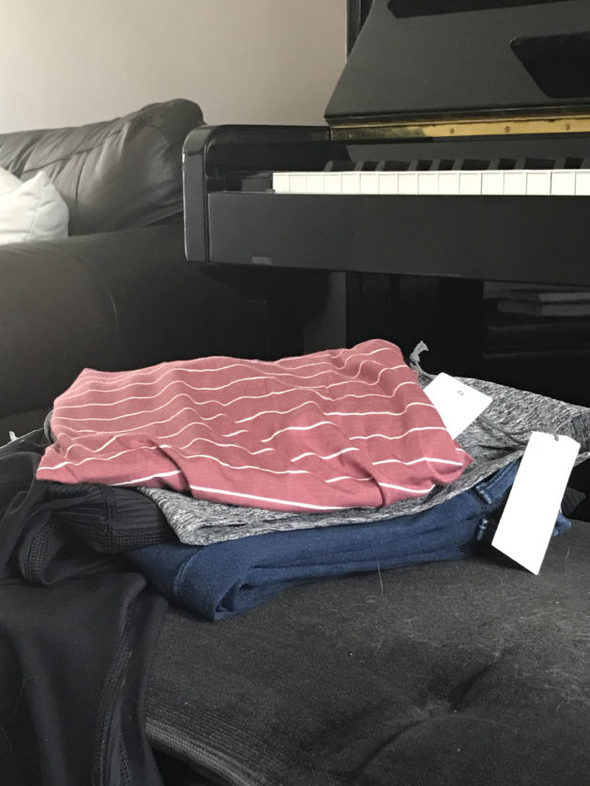 Stitch Fix clothes, folded up