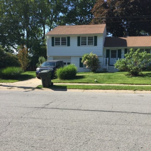 A white split-level house on a sunny day.