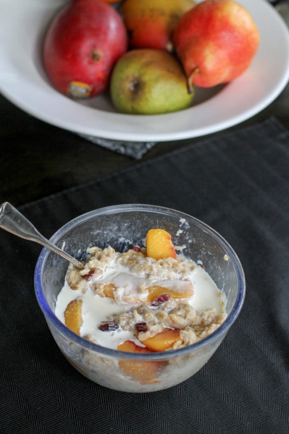 Peach cranberry oatmeal in a blue bowl.