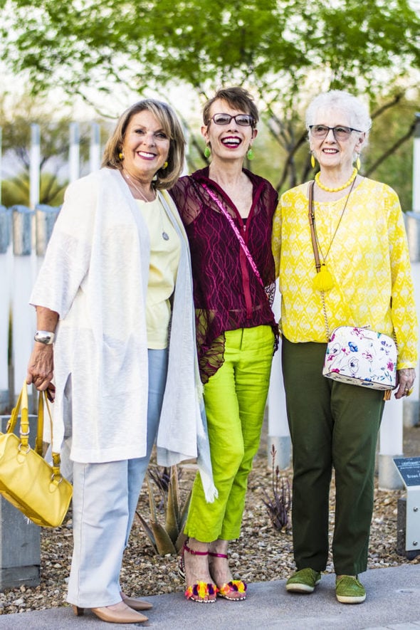 Three ladies dressed in spring outfits with fall colors.