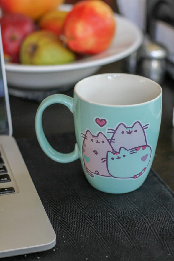 Green repaired Pusheen mug.