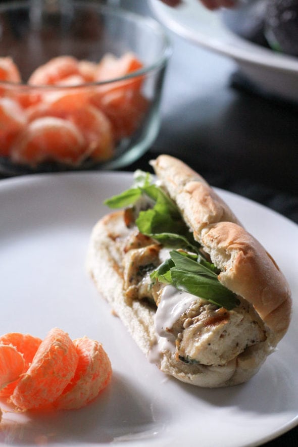 Chicken spiedies on a bun, with clementines.