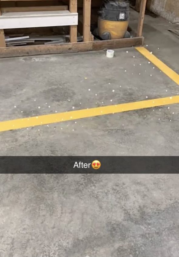 Freshly painted yellow floor line at a lumberyard.