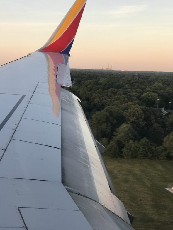 A Southwest plane wing at sunset.